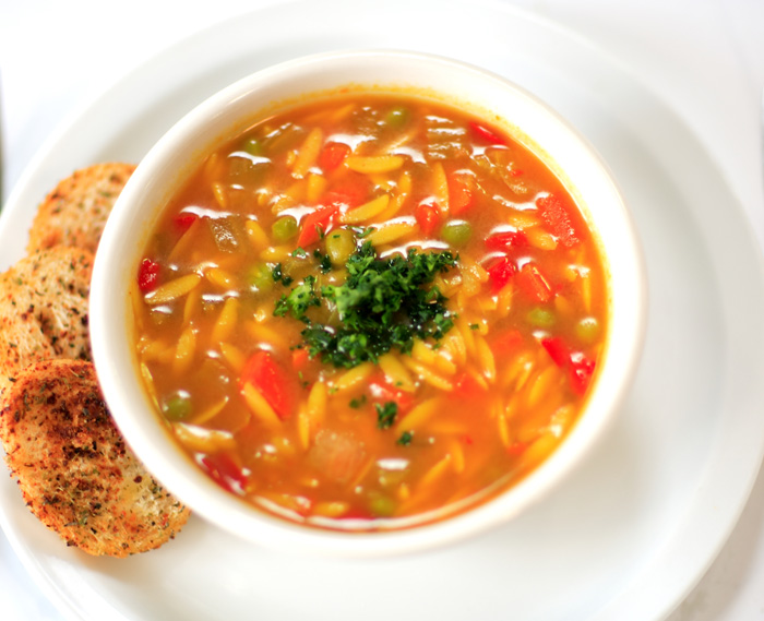 Hot and hearty vegetable soup; Served with sliced baguette and crouton